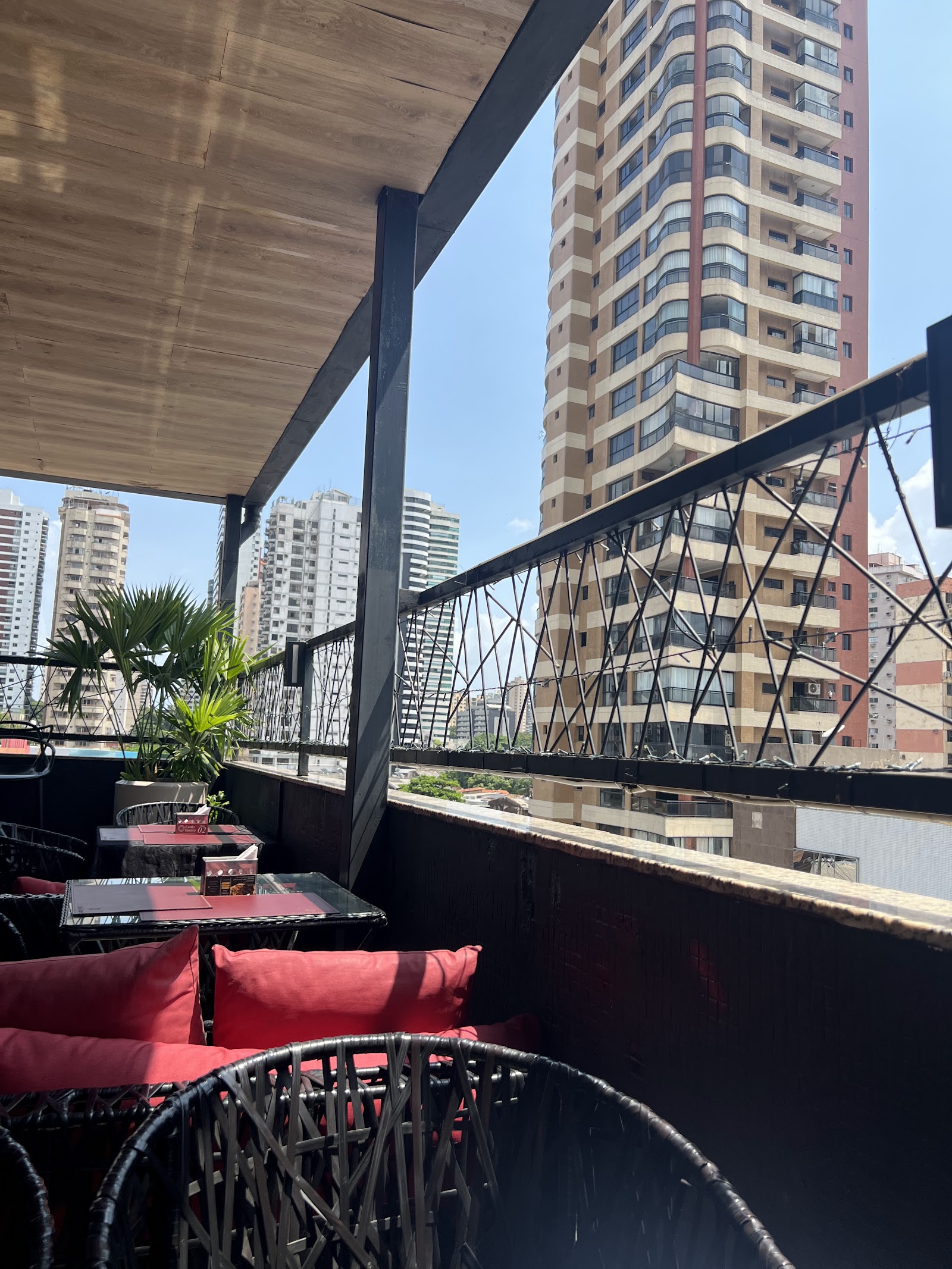 Varanda do rooftop com poltronas vermelhas